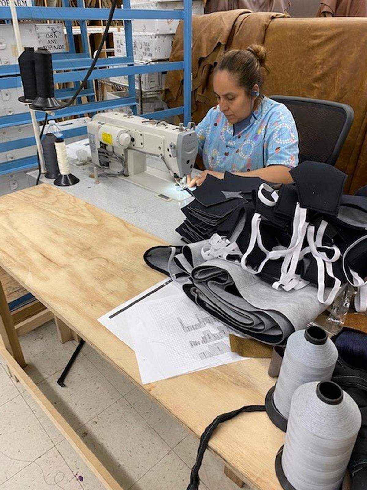 An employee of The Leather Sofa Co. works on making a face mask that could soon be used by a North Texas medical professional. The furniture company has transitioned to making protective masks to help hospitals that are running low due to the coronavirus.