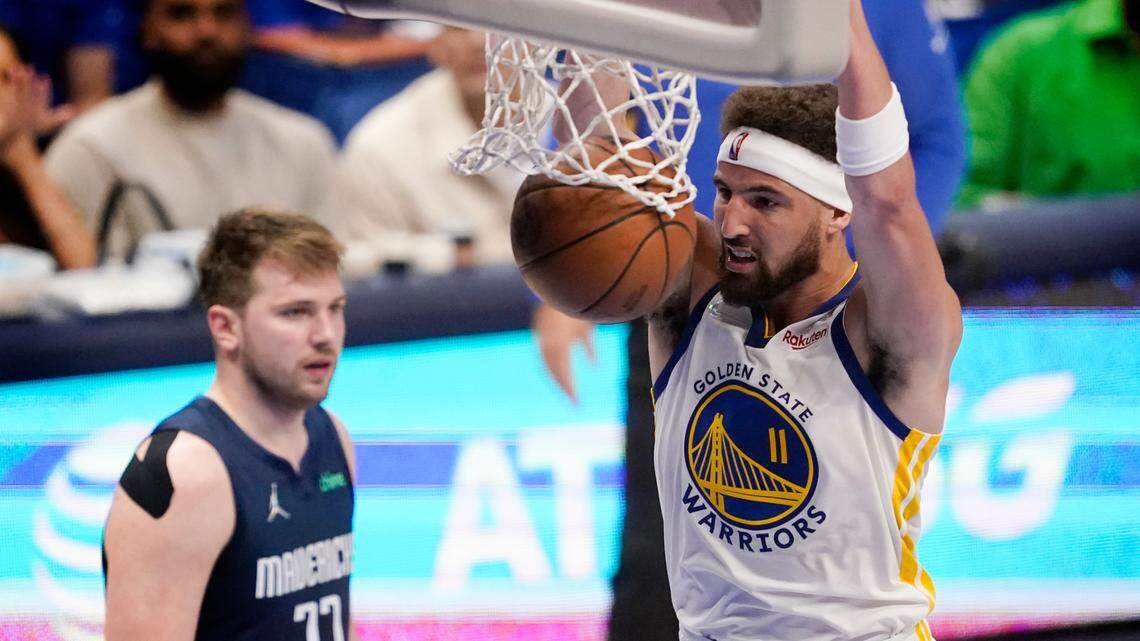 Golden State Warriors guard Klay Thompson (11) dunks the ball ahead of Dallas Mavericks guard Luka Doncic (77) during the second half of Game 3 of the NBA basketball playoffs Western Conference finals, Sunday, May 22, 2022, in Dallas. (AP Photo/Tony Gutierrez)