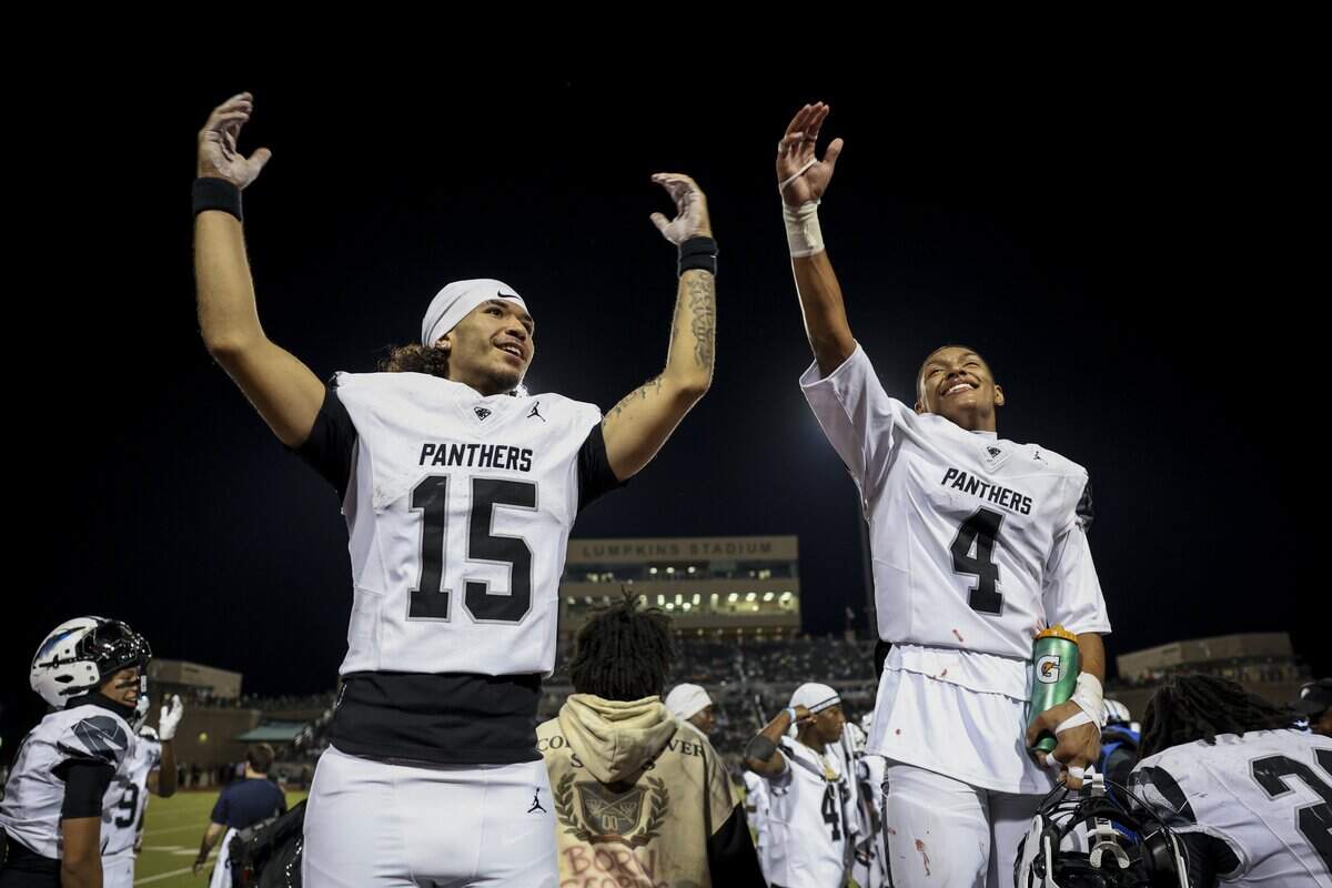 North Crowley quarterback Jacob Torres (15) and North Crowley cornerback Jerry Outhouse (4) celebrate defeating Waxahachie on Friday, Oct. 9, 2026, at Stuart B. Lumpkins Stadium in Waxahachie.