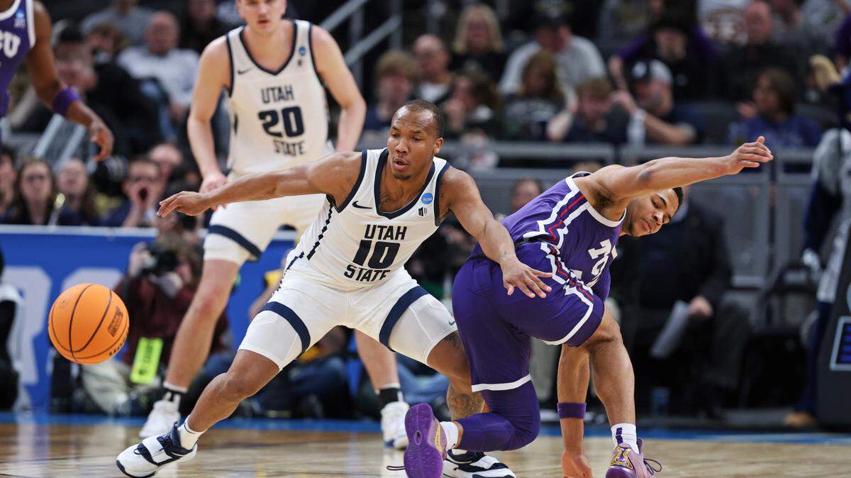 Utah State Aggies guard Darius Brown II (10) goes for the loose ball against the TCU Horned Frogs during the first half in the first round of the 2024 NCAA Tournament at Gainbridge FieldHouse on Friday.