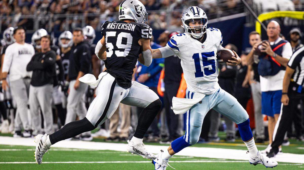 Dallas Cowboys quarterback Will Grier (15) stiff arms Las Vegas Raiders defender Luke Masterson (59) in the first half of a preseason game against the Las Vegas Raiders at AT&T Stadium in Arlington on Saturday.