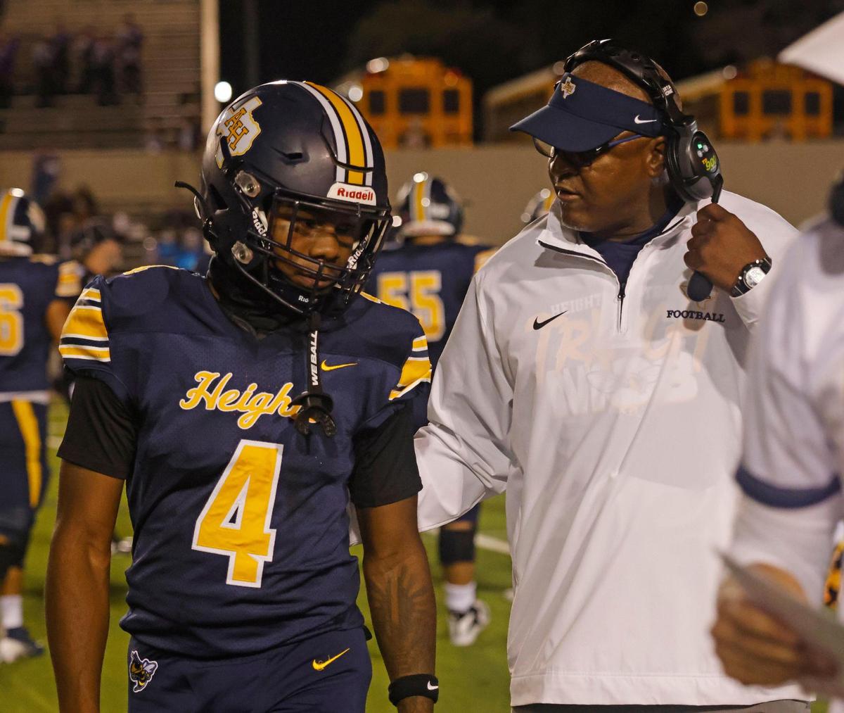 Arlington Heights head coach Curtis James talks to wide receiver DeShaun Long (4) about his decision to not let the ball go into the end zone during the Battle of the Bonfire UIL District 4-5A D1 football game at Farrington Field in Fort Worth, Texas, Friday, Nov. 08, 2024.