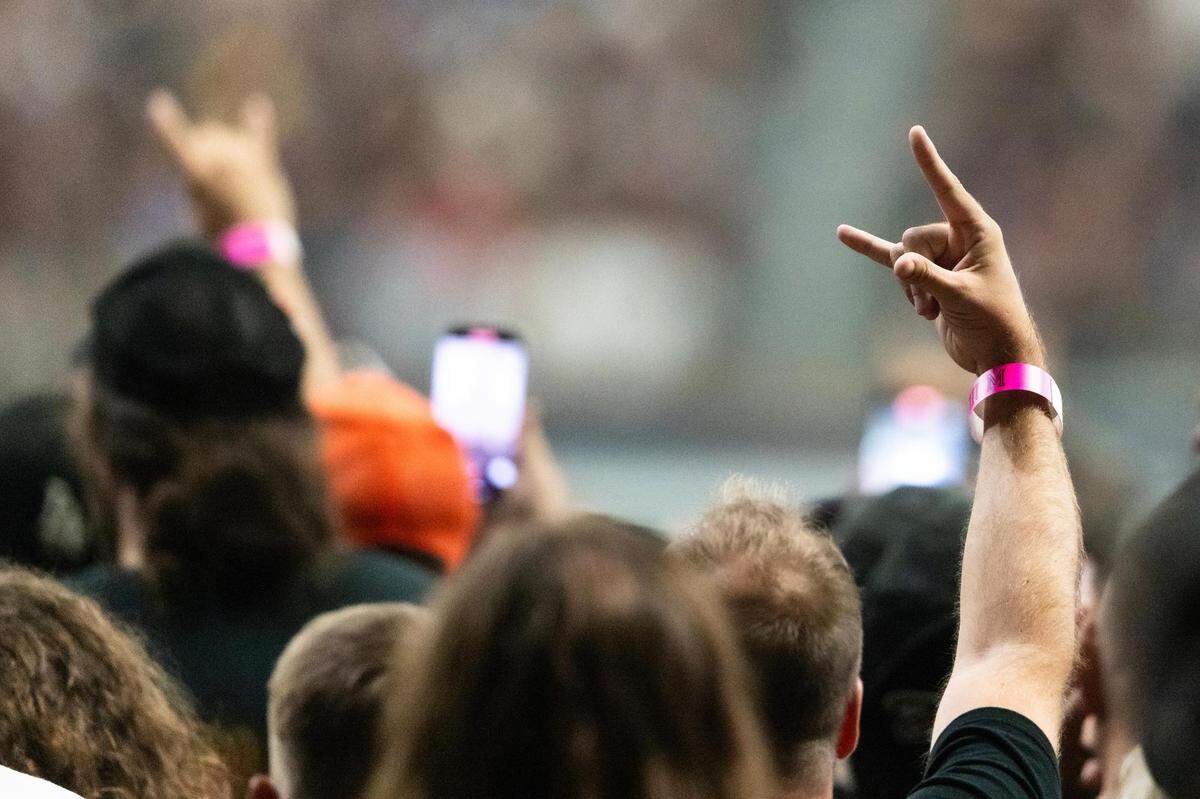 Fans throw up the rock hand gestures as the Metallica band members get on stage during the Metallica: M72 World Tour concert at AT&T Stadium in Arlington, Texas on Friday, Aug. 18, 2023.