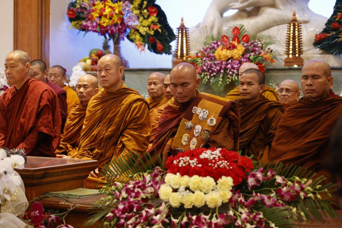 Buddhist monks who walked nearly 2,300 miles to Washington D.C. for Peace sit in the front of the Húóng Do Vipassana Bhavana Center in Fort Worth, Texas, Saturday Feb. 14, 2026.