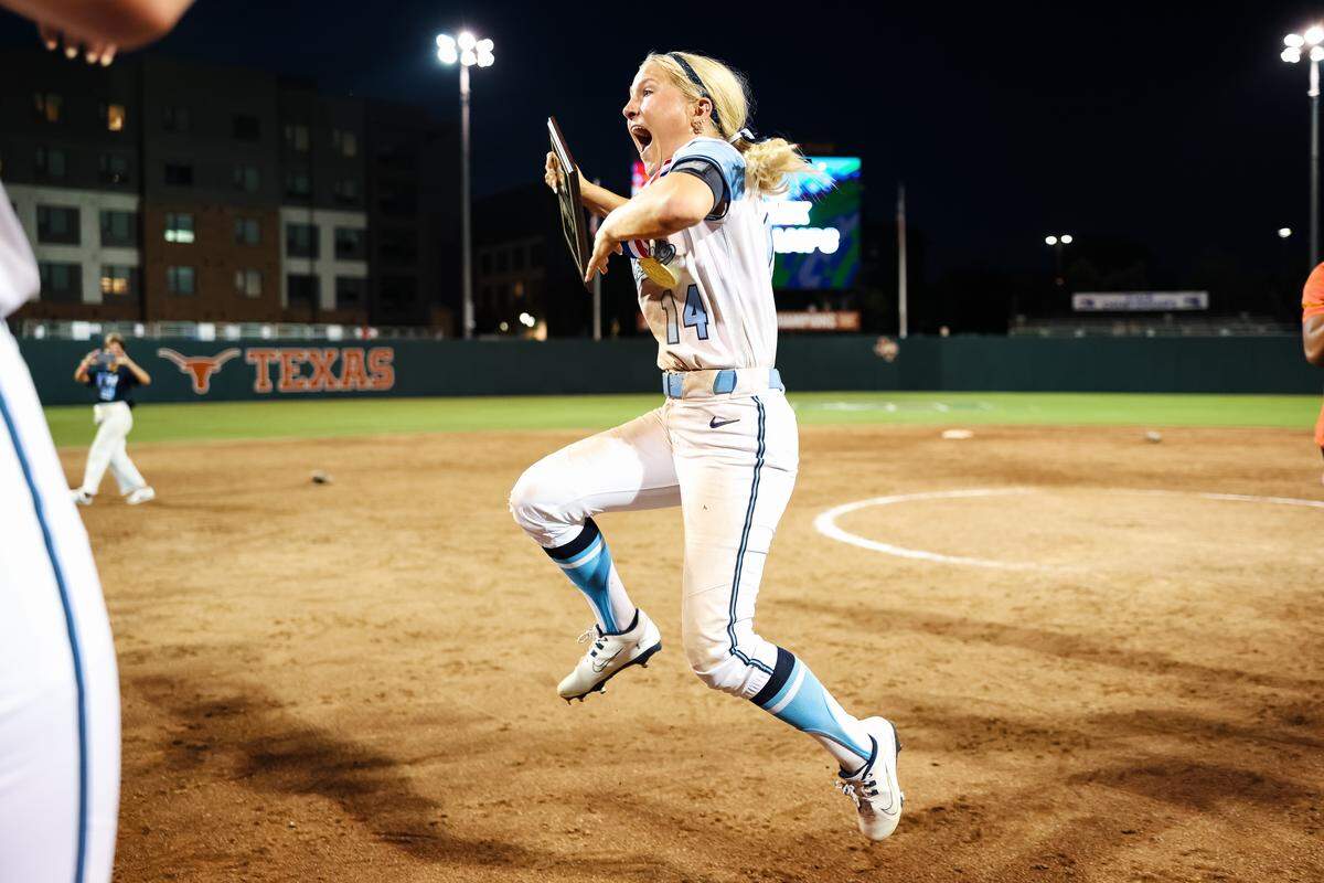 Montgomery Lake Creek centerfielder Madalyn Davis (14) jumps in celebration after being named Most Valuable Player against White Settlement Brewer in the UIL Class 5A Division II state softball championship game at Red & Charline McCombs field in Austin, Texas, on Friday, May 29, 2026.