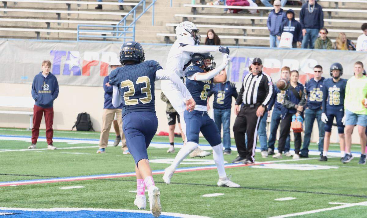 Fort Worth Covenant Classical’s Hudson Williams (8) breaks up a pass intended for Huntsville Alpha Omega’s Colton Sikes (6) as Jesse Peach (23) looks on in the TAPPS Six-Man Division II Championship game on Thursday, Dec. 5, 2024 at Waco ISD Stadium in Waco, Texas.