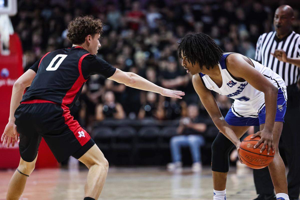 Mansfield Summit guard Sam Getnet (2) holds the ball as a Lovejoy defender puts his hand toward Getnet in defense during a Class 5A Division II state semifinal at Moody Coliseum in Dallas, March 10, 2026.