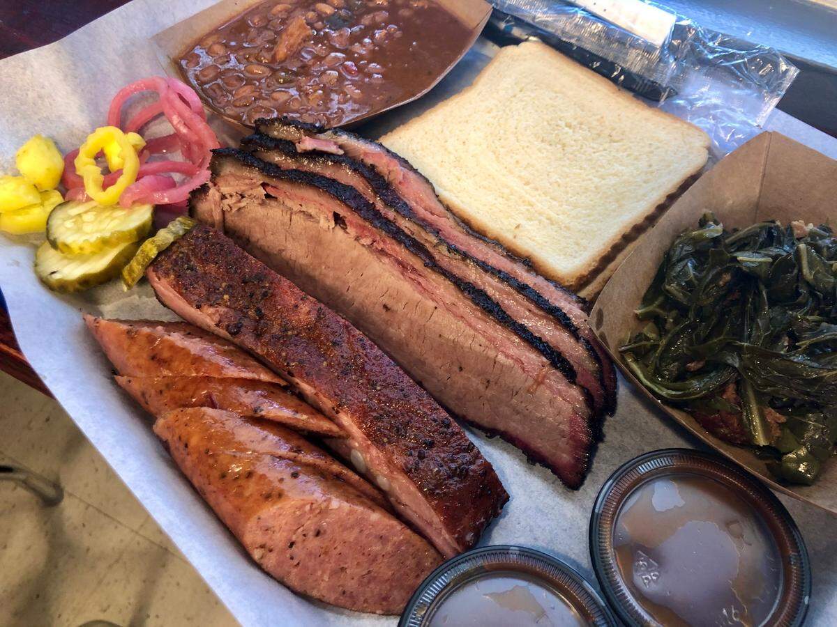 A combo plate at Smoke-A-Holics BBQ with collard greens and baked beans.