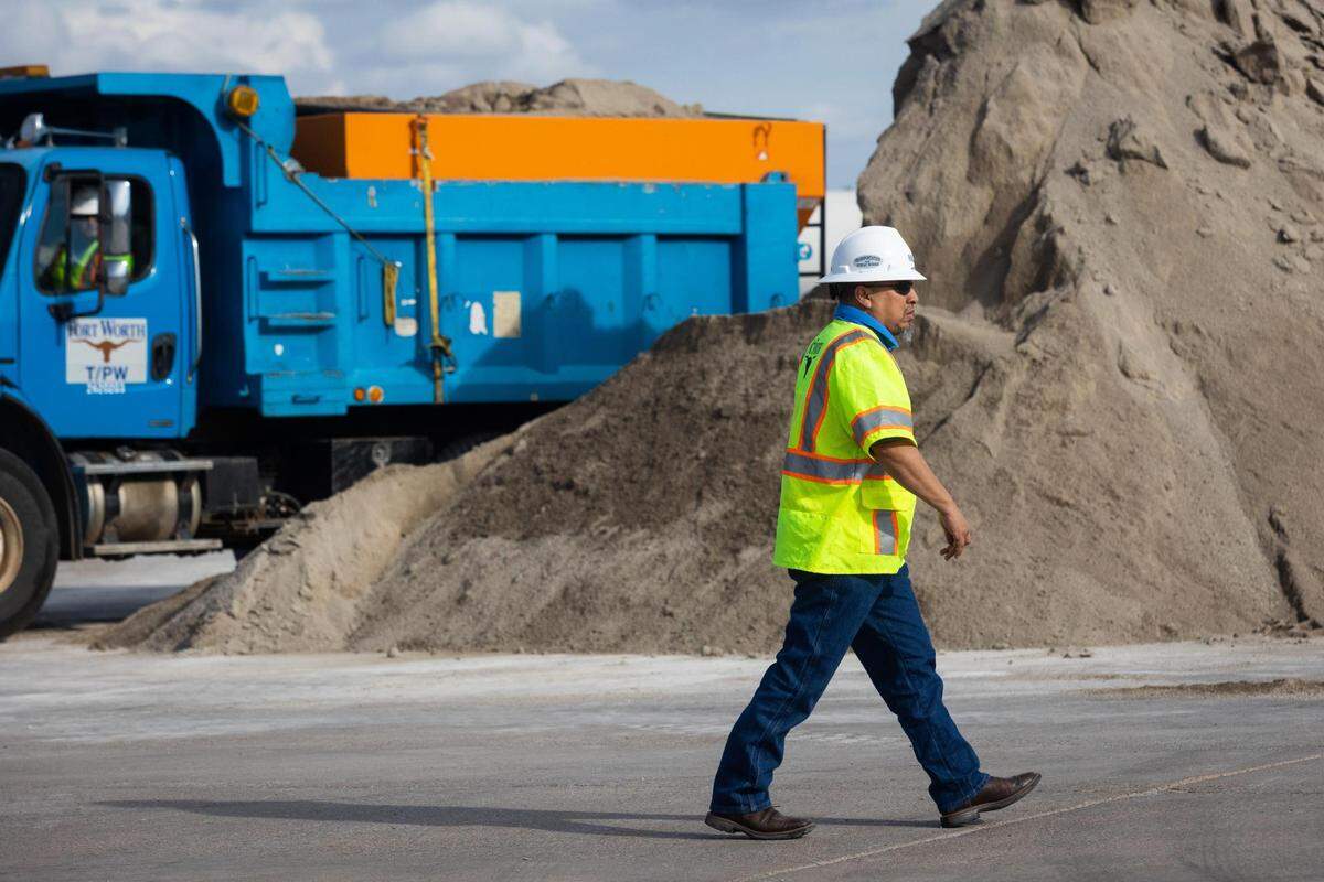Timothy Moreno, transportation and public works superintendent, watches as a tractor loads sand and salt mixture to fluff up as the city prepares for a winter storm Monday, Jan. 31, 2022, in Fort Worth.