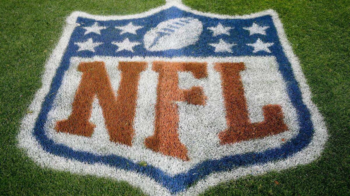 FILE - In this Nov. 12, 2017, file photo, an NFL logo is displayed on the field before an NFL football game between the New England Patriots and the Denver Broncos in Denver. (AP Photo/Jack Dempsey, File)