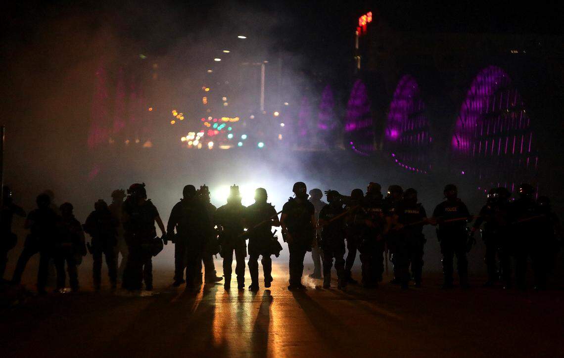 The Fort Worth police retake the West 7th Street bridge after protesters blocked the flow of traffic for about three hours on Sunday, May 31, 2020. The police used dispersal smoke, flash-bangs and tear gas to disperse the crowd.