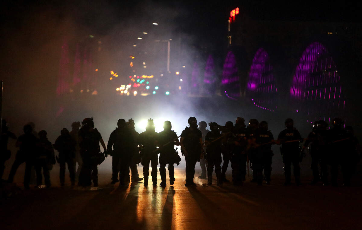The Fort Worth police retake the West 7th Street bridge after protesters blocked the flow of traffic for about three hours on Sunday, May 31, 2020. The police used dispersal smoke, flash-bangs and tear gas to disperse the crowd.