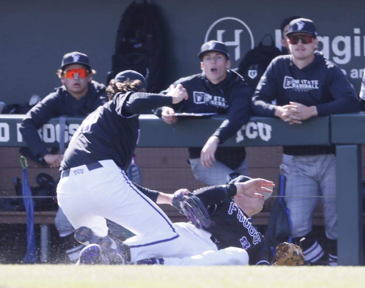 TCU first baseman Lane Hutchinson (8) and pitcher Cade Nelson (34) collided in front of the New Mexico State dugout as Hutchinson came up with the ball during an NCAA baseball game at Lupton Field at TCU in Fort Worth, Texas, Tuesday, March, 17, 2026.