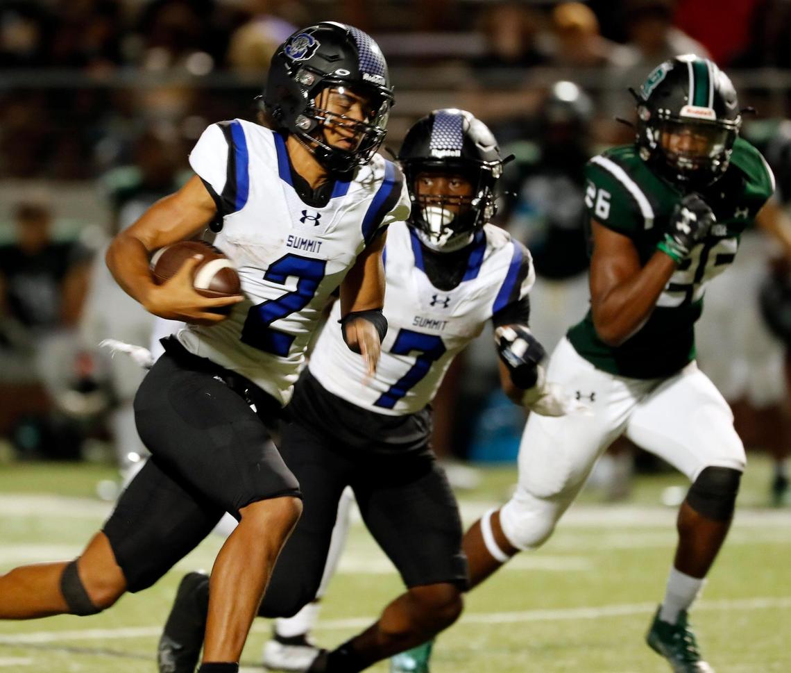 Summit quarterback Joseph Williams (2) takes it all the way to the end zone accompanied by running back Amare Burgess (7) in the second half of a high school football game at Vernon Newsom Stadium in Mansfield, Texas, Friday, Aug. 26, 2022. Lake Ridge defeated Summit 50-27 . (Special to the Star-Telegram Bob Booth)