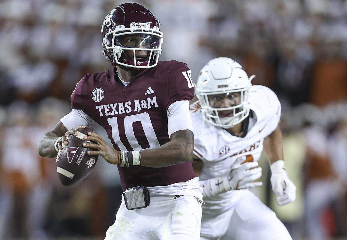 Nov 30, 2024; College Station, Texas, USA; Texas A&M Aggies quarterback Marcel Reed (10) looks for an open receiver as Texas Longhorns linebacker Trey Moore (8) defends during the fourth quarter at Kyle Field. Mandatory Credit: Troy Taormina-Imagn Images