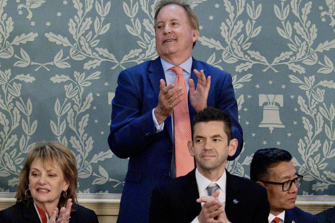 Texas Attorney General Ken Paxton (top) stands and applauds as U.S. President Donald Trump delivers his State of the Union address during a Joint Session of Congress at the U.S. Capitol on February 24, 2026, in Washington, D.C.
