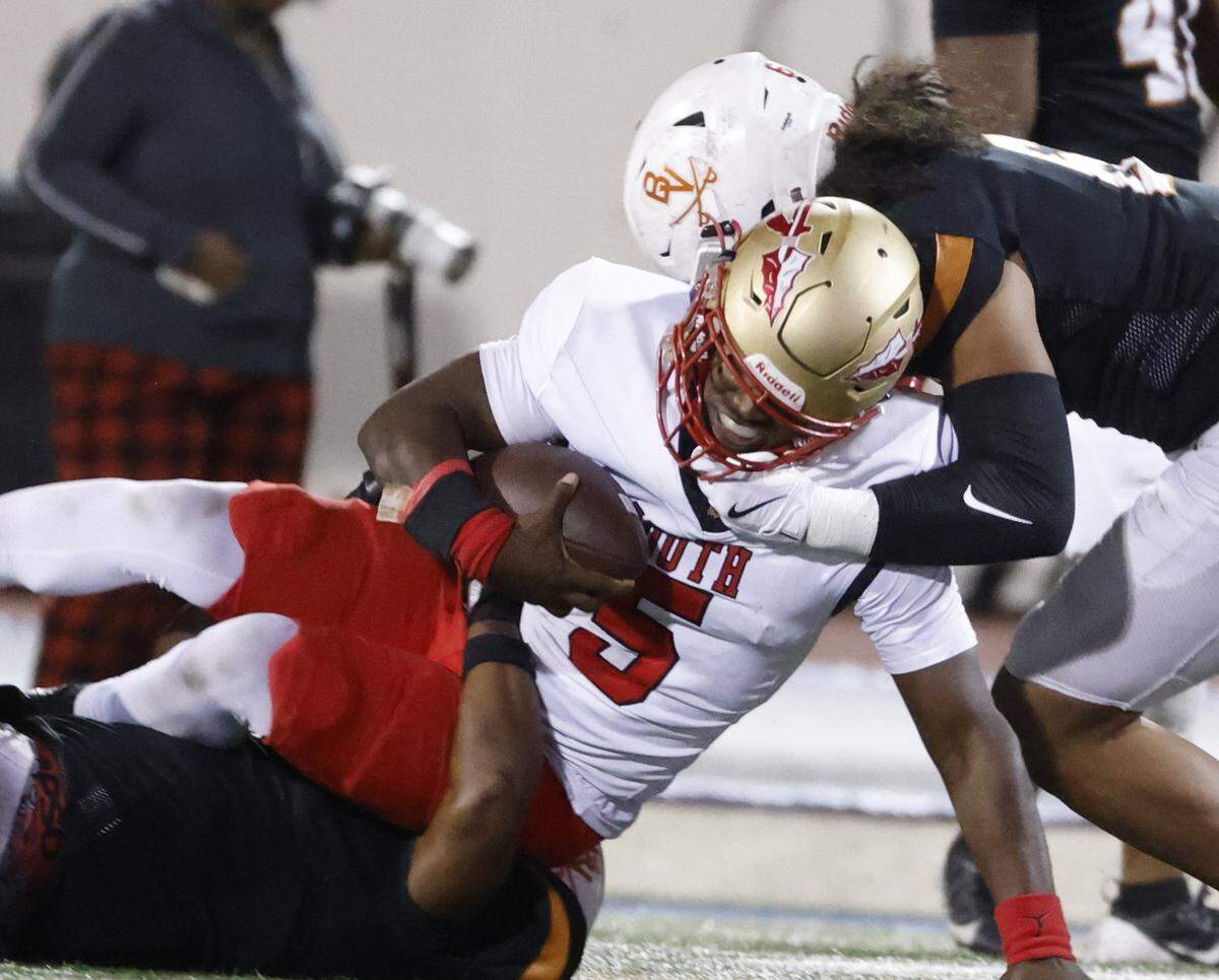 South Grand Prairie quarterback Daylon Brooks (5) is dropped at the line during the second half of a UIL football game between South Grand Prairie and Arlington Bowie at UTA Maverick Stadium in Arlington, Texas, Thursday Nov. 06, 2025.