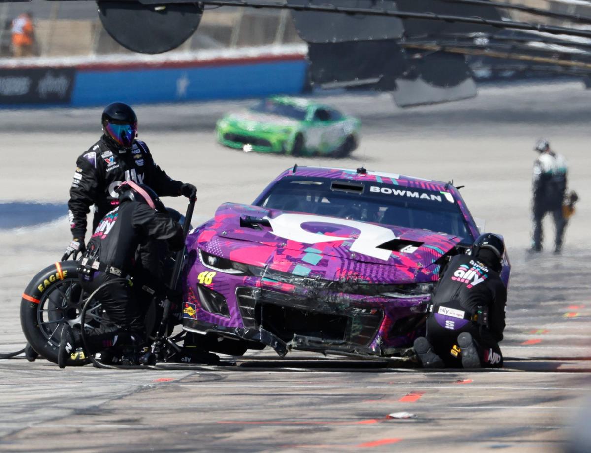 The pit crew of Alex Bowman (48) works on his damaged front end during the Auto Trader Echo Park 400 at Texas Motor Speedway in Fort Worth, Texas, April 14, 2024. Kyle Larson won stage 1. (Special to the Star-Telegram/Bob Booth)