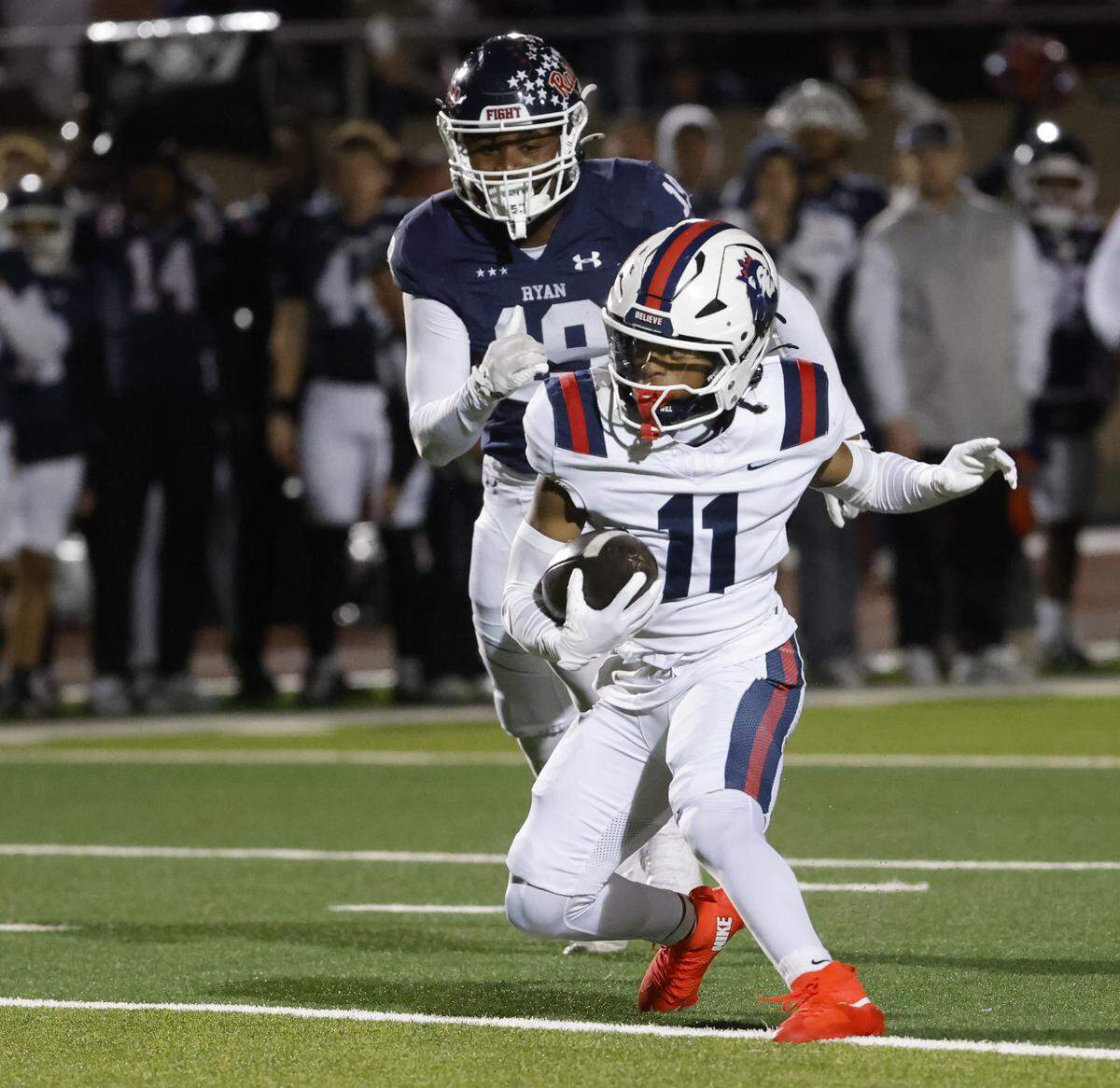 Richland wide receiver Aaron Brooks (11) makes a move against Denton Ryan linebacker TJ Johnson (19) in the middle of the field during the first half of a UIL Class 5A Division I Regional on Friday Nov. 28, 2025 at Buddy Echols Field in Coppell, Texas.