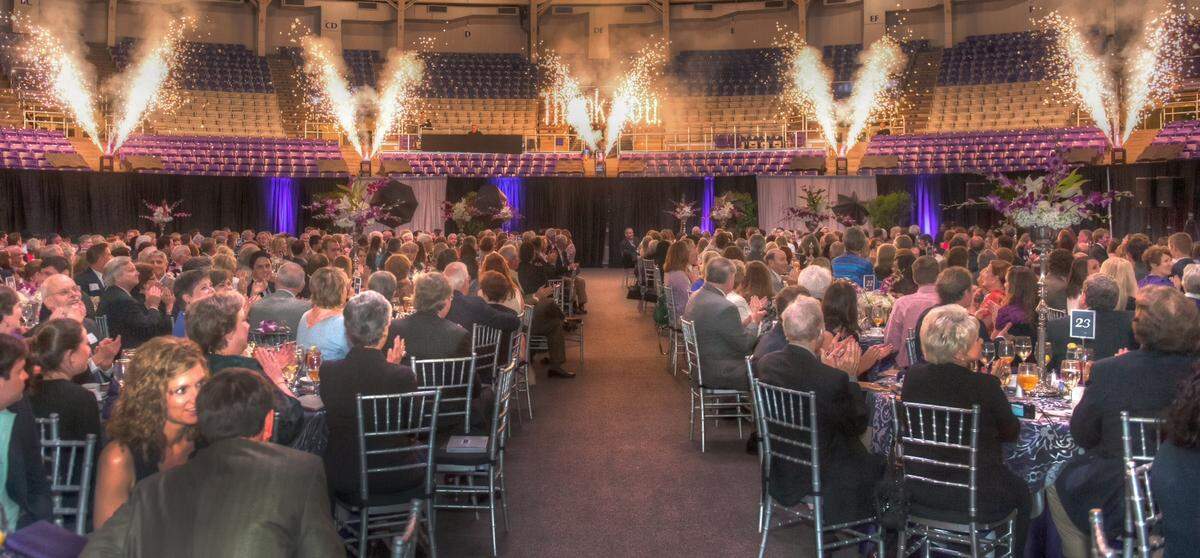 An indoor pyro effect overlooks a Texas Christian University fundraising dinner.
