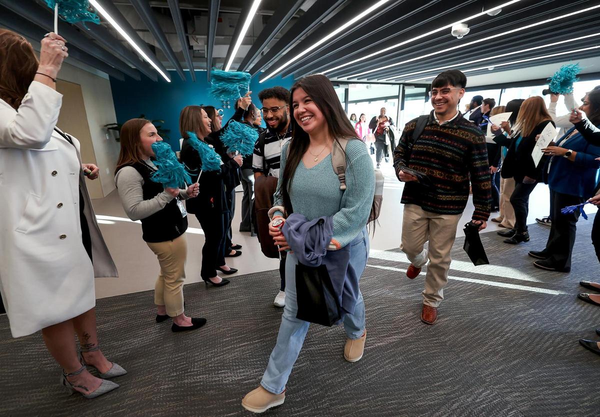 Faculty and staff greet new nursing students Daniel Lee-Munoz, left, Estrella Carretero, center, and her brother, Alberthy Carretero, right to their first class at the new College of Nursing School at University of North Texas Health Science Center on Monday, Jan. 13, 2025, in Fort Worth.