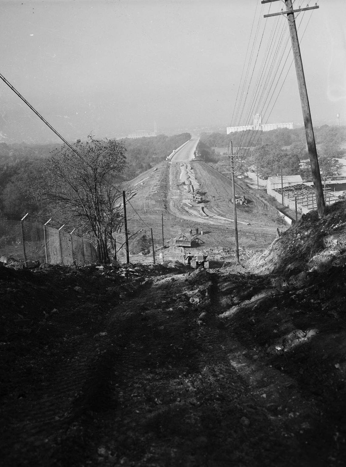 Nov. 12, 1941: Construction work began in Fort Worth on the $134,000 cut and fill to link the east end of Trinity River Bridge with West Lancaster Avenue at Summit Avenue. The view, west from the bluff above the bridge, shows 12-foot graders at work.