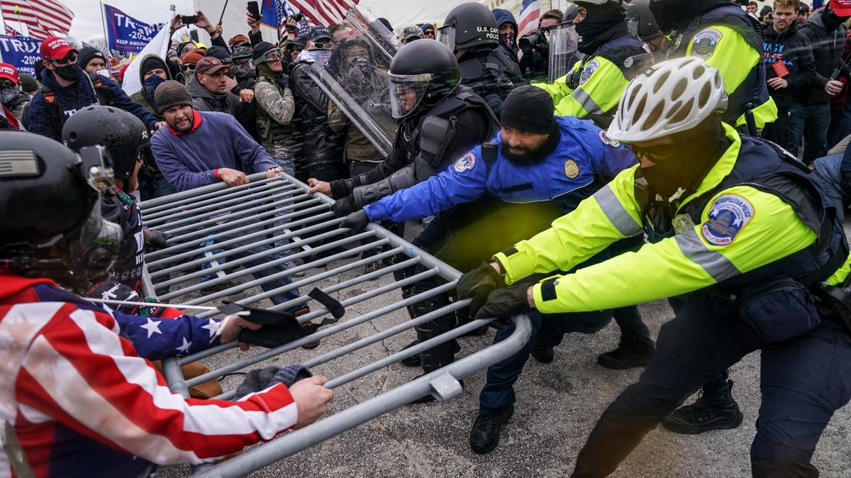 FILE - insurrections loyal to President Donald Trump try to break through a police barrier, Wednesday, Jan. 6, 2021, at the Capitol in Washington. The Department of Justice is prosecuting those who violently stormed the Capitol. More than 870 people have been charged and more than 400 convicted. (AP Photo/John Minchillo, File)