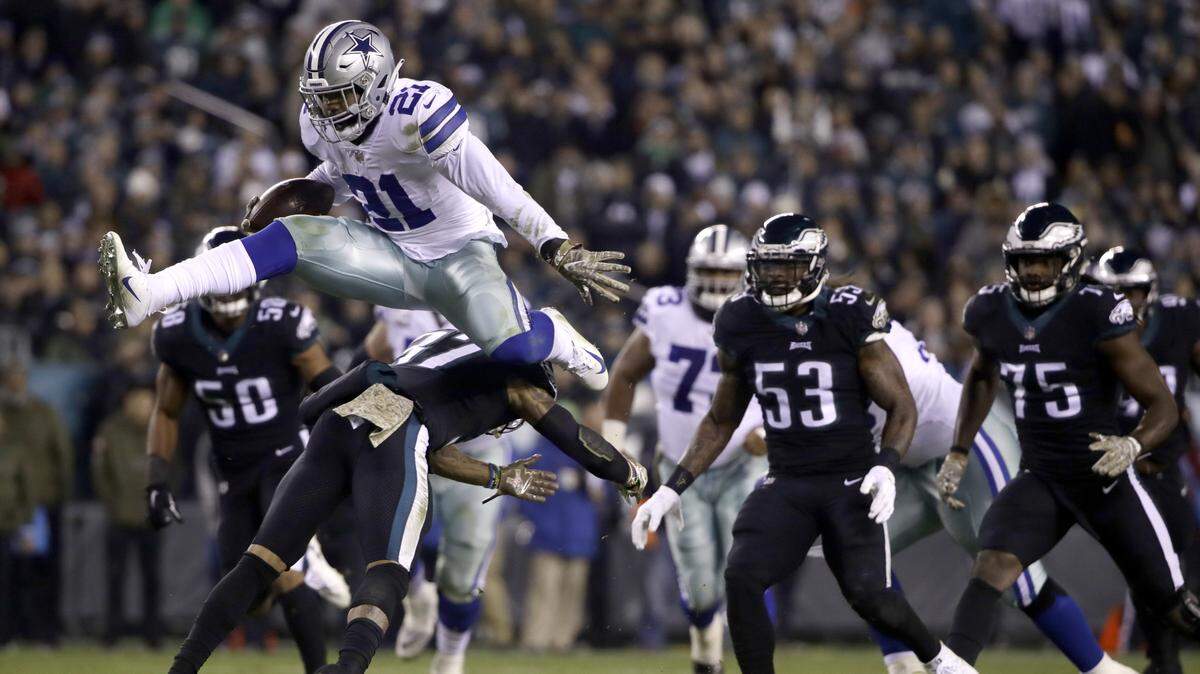 Dallas Cowboys running back Ezekiel Elliott hurdles over Philadelphia Eagles defensive back Tre Sullivan during the first half of an NFL football game, Sunday, Nov. 11, 2018, in Philadelphia.