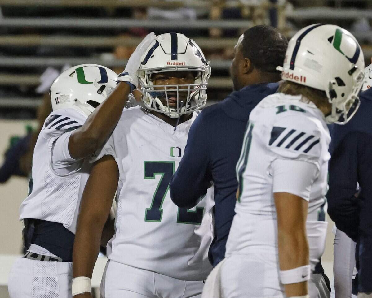 Oakridge defensive lineman Easton Jefferson (72) gets a congratulatory pat on the head after scoring a defensive touchdown from a tipped pass during the first half of the SPC 2025 3A Football Championship football game between The Oakridge School and Fort Worth Country Day at Mavericks Stadium in Arlington, Texas, Saturday Nov. 08, 2025.
