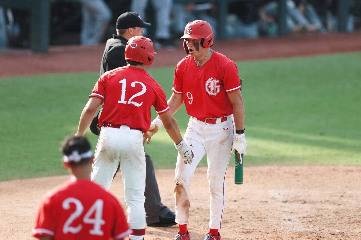Grapevine outfielder Brady Boozer (9) yells and high fives his teammate Jarett Boswell (12) after scoring in the Class 5A Division II state championship game against Kingwood Park on Friday, June 6, 2025 at Dell Diamond in Round Rock, Texas.