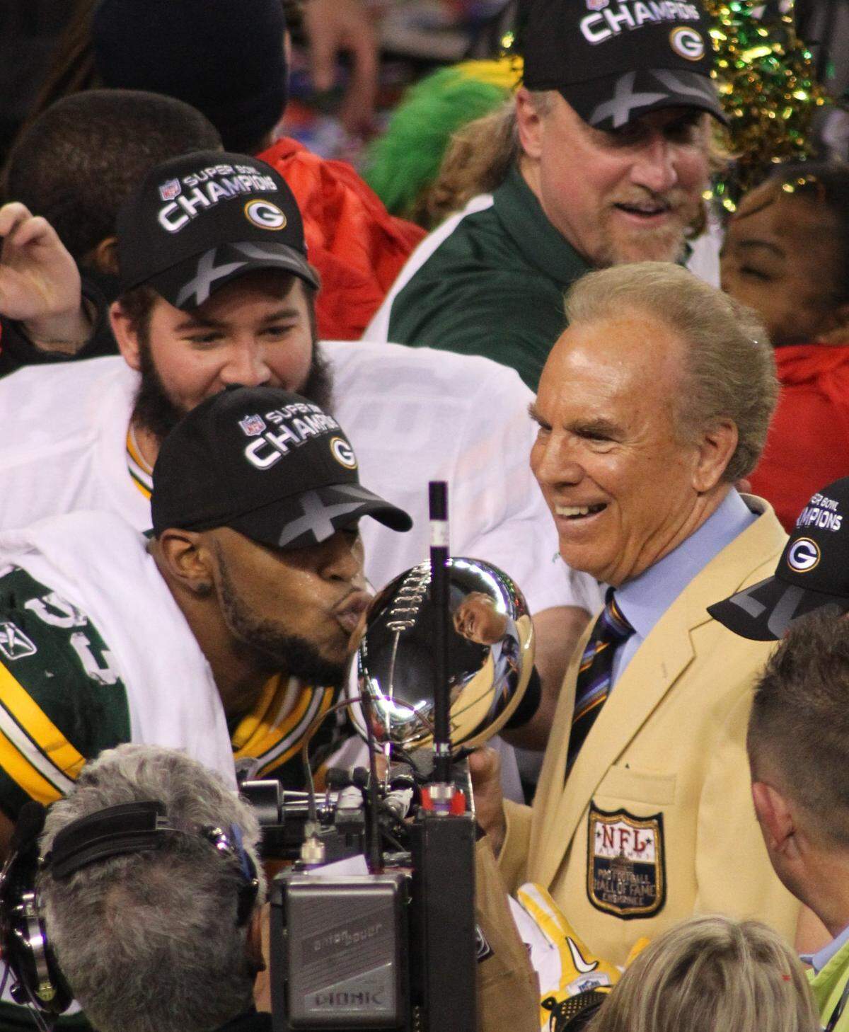 Green Bay Packers linebacker Diyral Briggs (53)  kisses the Vince Lombardi  Trophy as Roger Staubach  brings it onto the field during Super Bowl XLV, Green Bay Packers vs the Pittsburgh Steelers in Arlington, Texas. February 6, 2011(Star-Telegram/Paul Moseley)