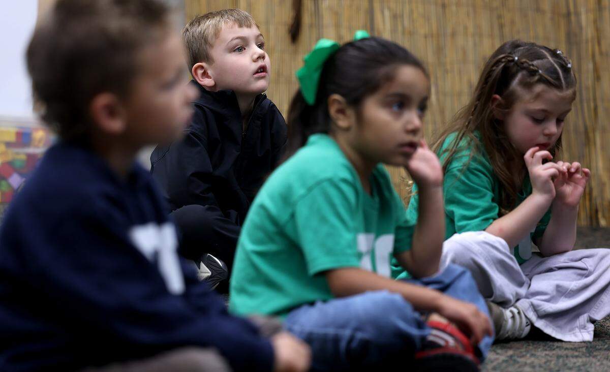 Nolan Guest, 4, center, listens intensely during a lesson on at Zoo School on Thursday, April 30, 2026. Zoo School is an enrichment program for children ages 3 to 5 that focuses on building social skills and knowledge of animals and their habitats. 
