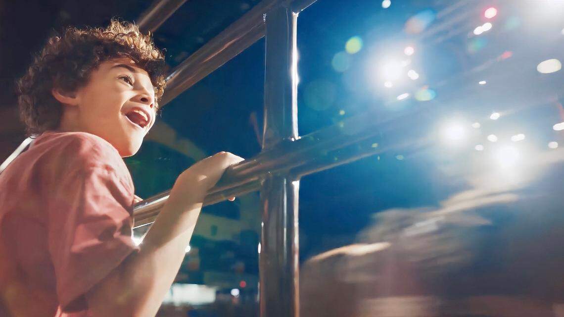 A scene from a Fort Worth tourism commercials shows a child watching in wonder at a rodeo grand entry.