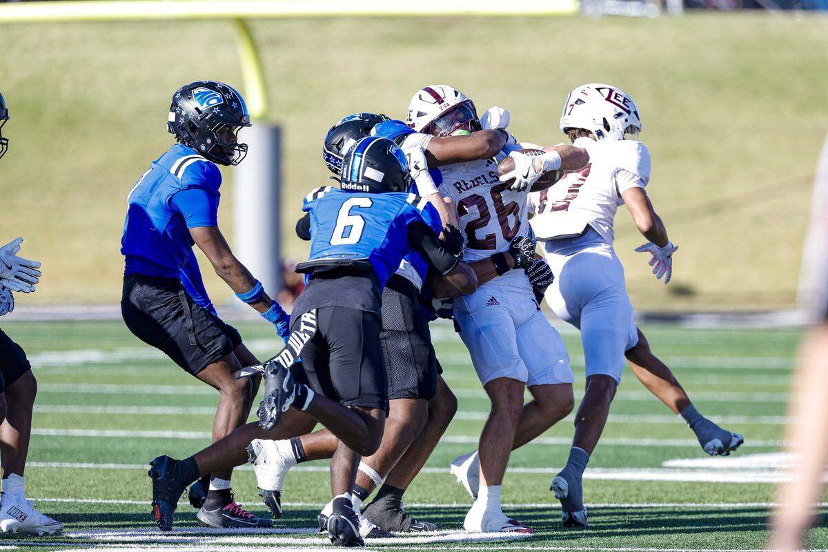North Crowley defensive back Thomas Cook (6) closes in to help teammates bring down Midland Legacy running back Hayes Hamm (26) for a short gain in a Class 6A Division I area-round playoff Saturday at Shotwell Stadium in Abilene.