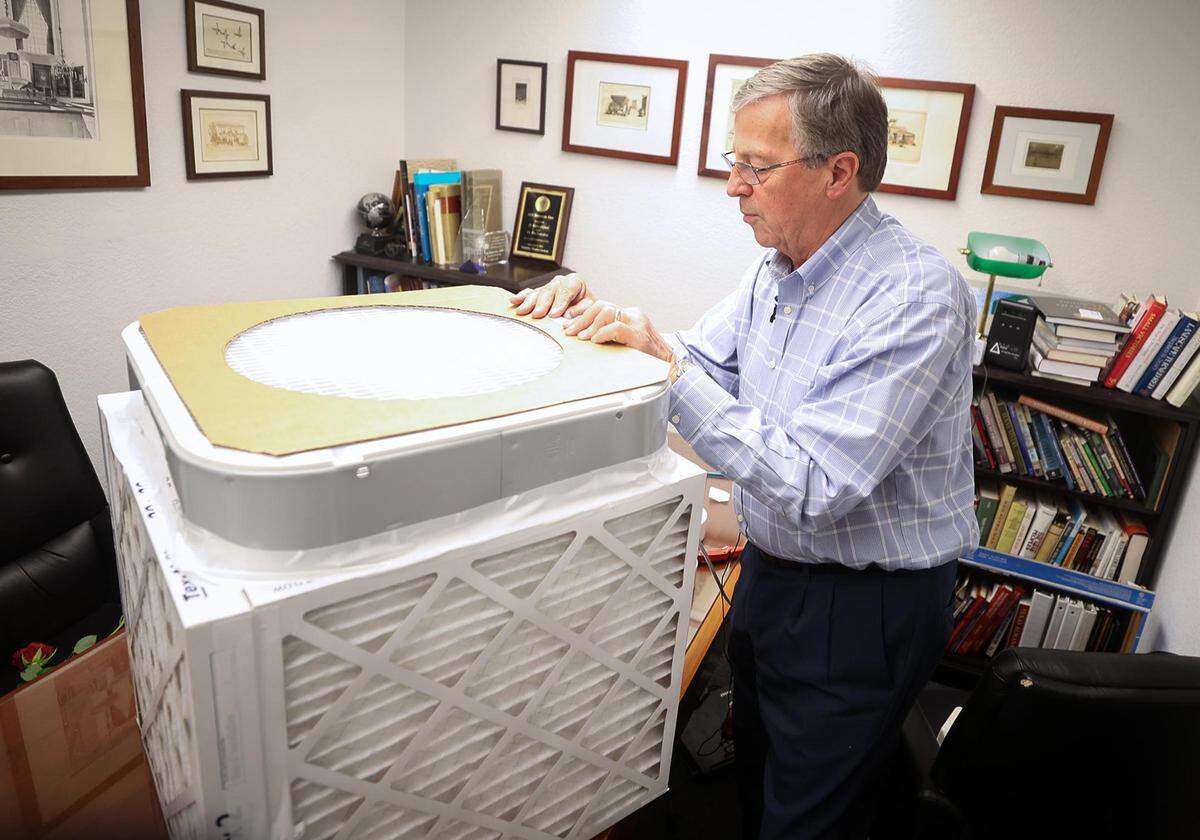 Jim Rosenthal, co-inventor of the Corsi-Rosenthal box, demonstrates how to assemble an air purifier made from a box fan, some tape, and four MERV-13 filters.
