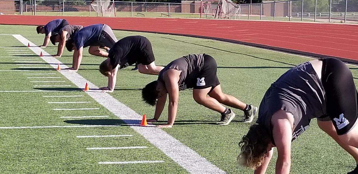 Mansfield football players work out on Monday, June 8, 2020.