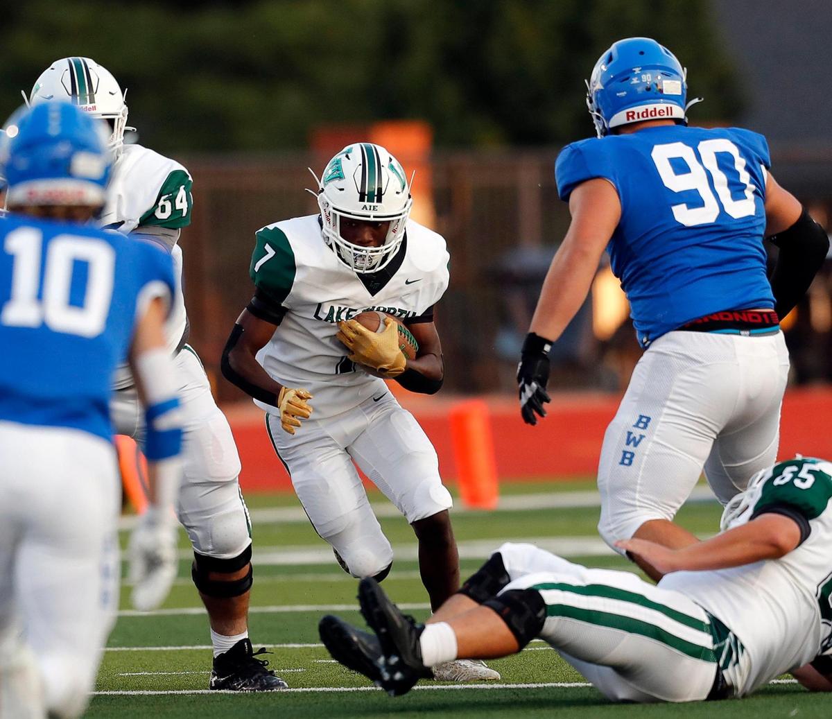 Lake Worth running back Damien Moore (7) looks for room in the middle during a high school football game at Owl Stadium in Joshua, Texas, Friday, Sept. 10, 2021. Lake Worth led Joshua by one at the half. (Special to the Star-Telegram Bob Booth)
