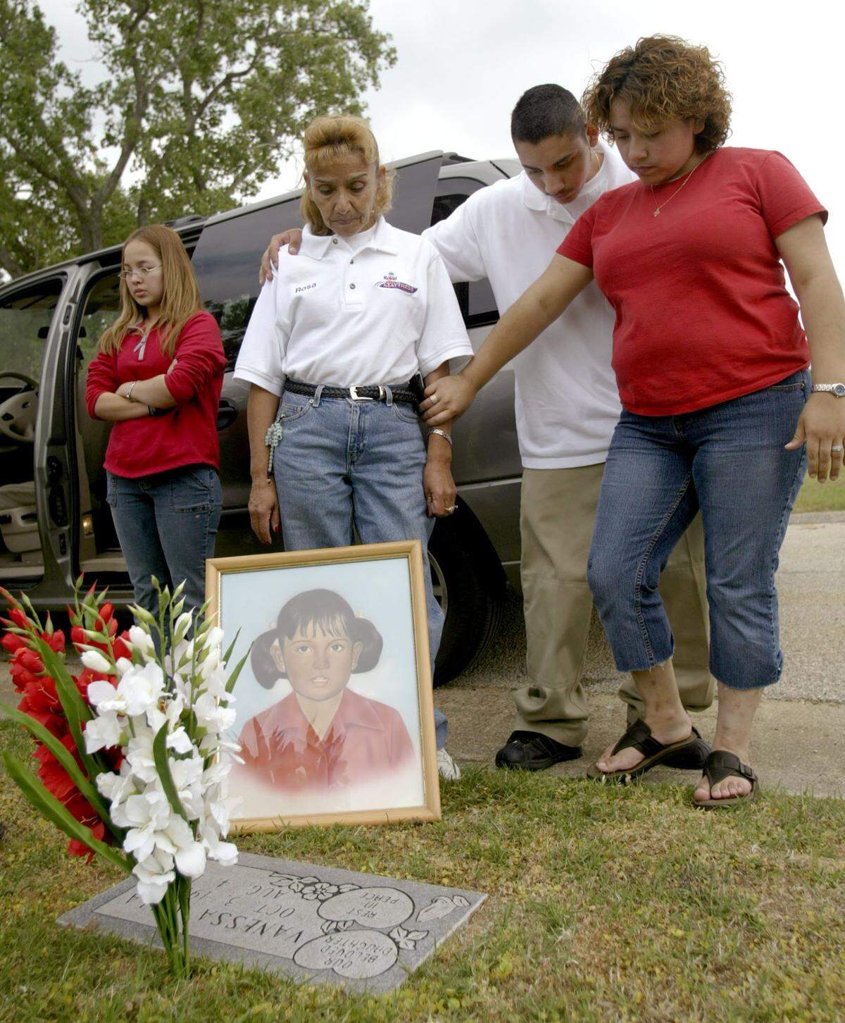 Rosa Maria Clark with her daughter, Denisse Perez, (right) and son, Pedro Perez, at Vanessa Villa’s grave in April 2005 after learning an arrest had been made in the case. On the left is Lucia Rosales, Vanessa’s sister-in-law.
