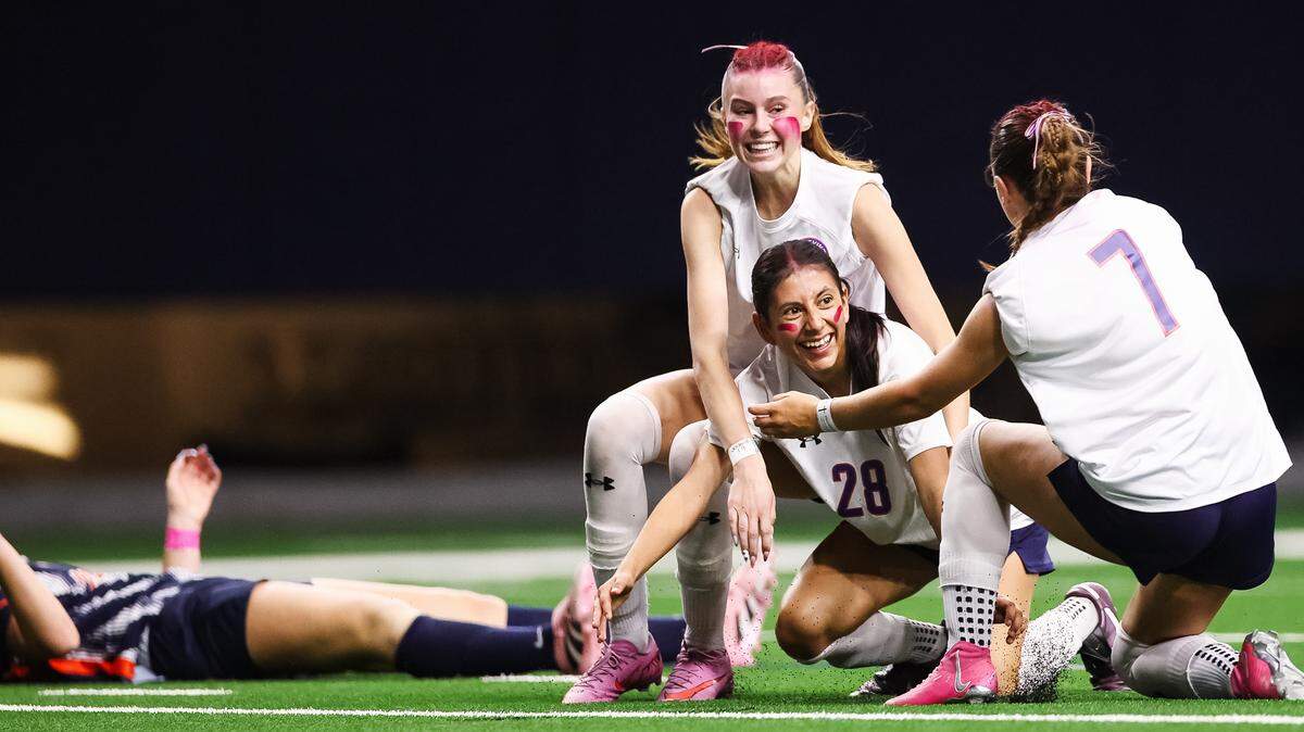 Grapevine’s Hope Harvill (7) and Chloe O’Steen (top) celebrate with Paola Granados (28), who scored the only goal of the match in a Class 5A Division II state semifinal against Frisco Wakeland on Friday at the Ford Center in Frisco.