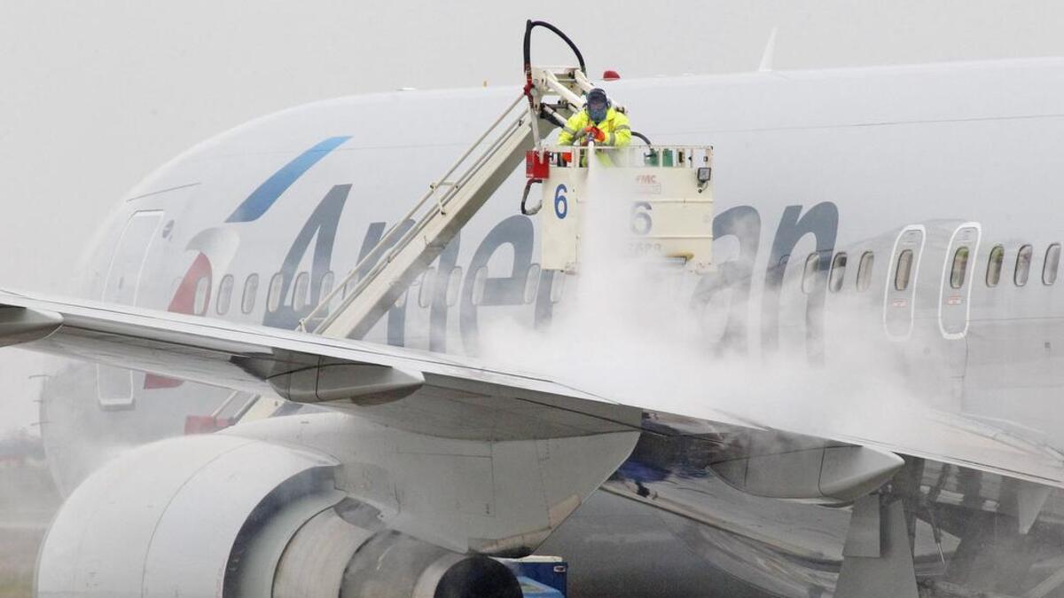 An American Airlines jet gets de-iced at DFW airport during a February 2015 ice storm.