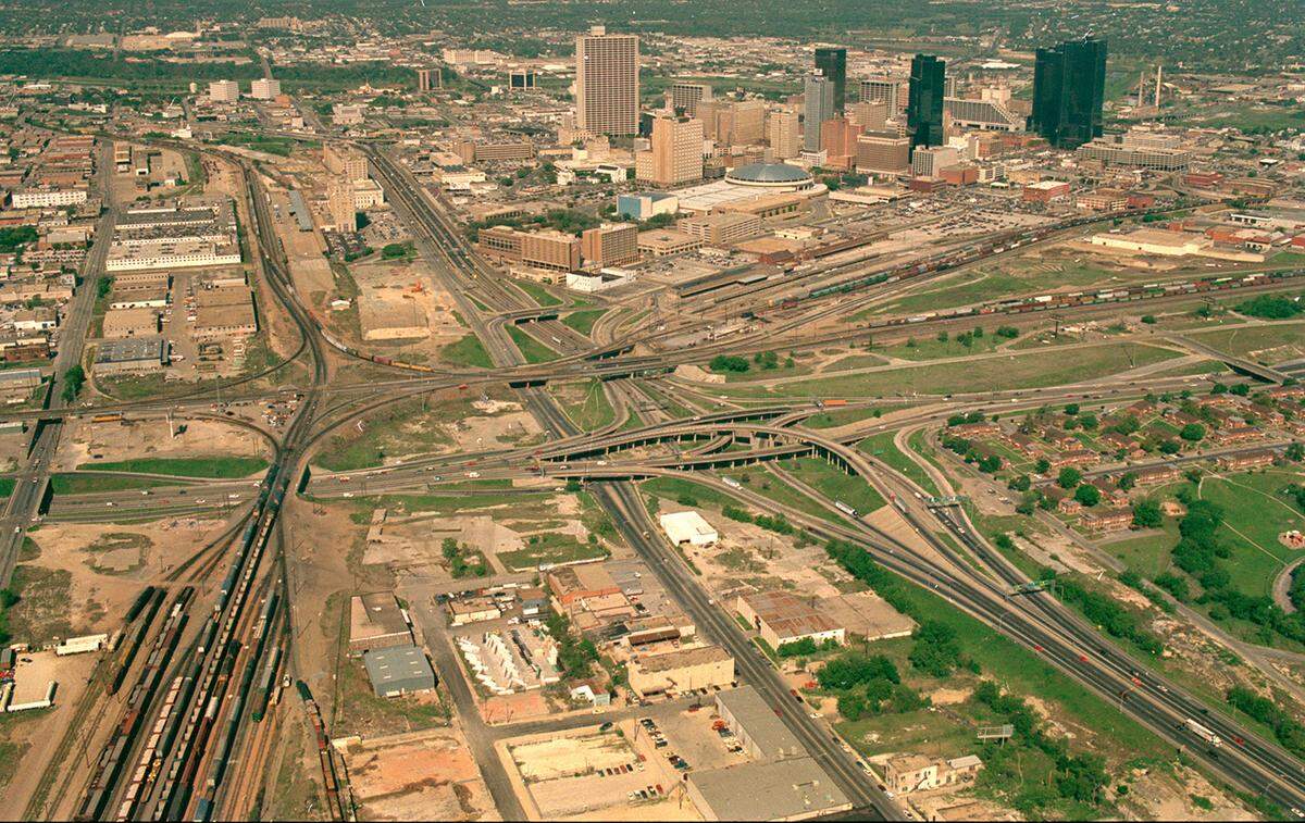 April 1990: An aerial of downtown Fort Worth, looking northwest at the Mixmaster interchange of Interstates 35 and 30. This photo shows where Interstate 30 was an elevated highway over West Lancaster Avenue, a decade before it was realigned to the south closer to the railroad tracks.
