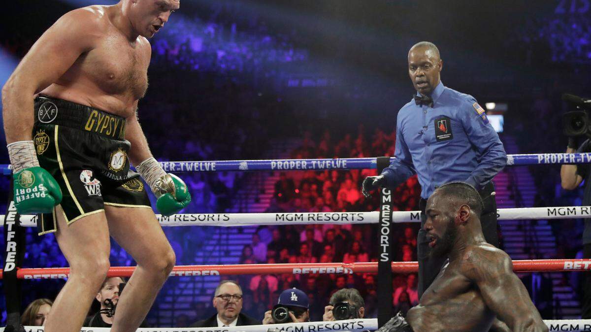 Tyson Fury, of England, knocks down Deontay Wilder during a WBC heavyweight championship boxing match Saturday, Feb. 22, 2020, in Las Vegas. (AP Photo/Isaac Brekken)
