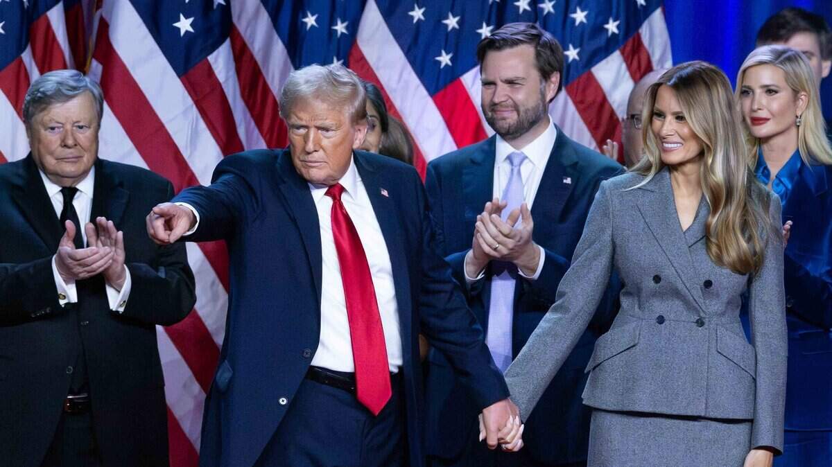 Donald Trump holds hands with wife Melania at his Election Night Watch Party at the Palm Beach County Convention Center after being elected the 47th President of the United States.