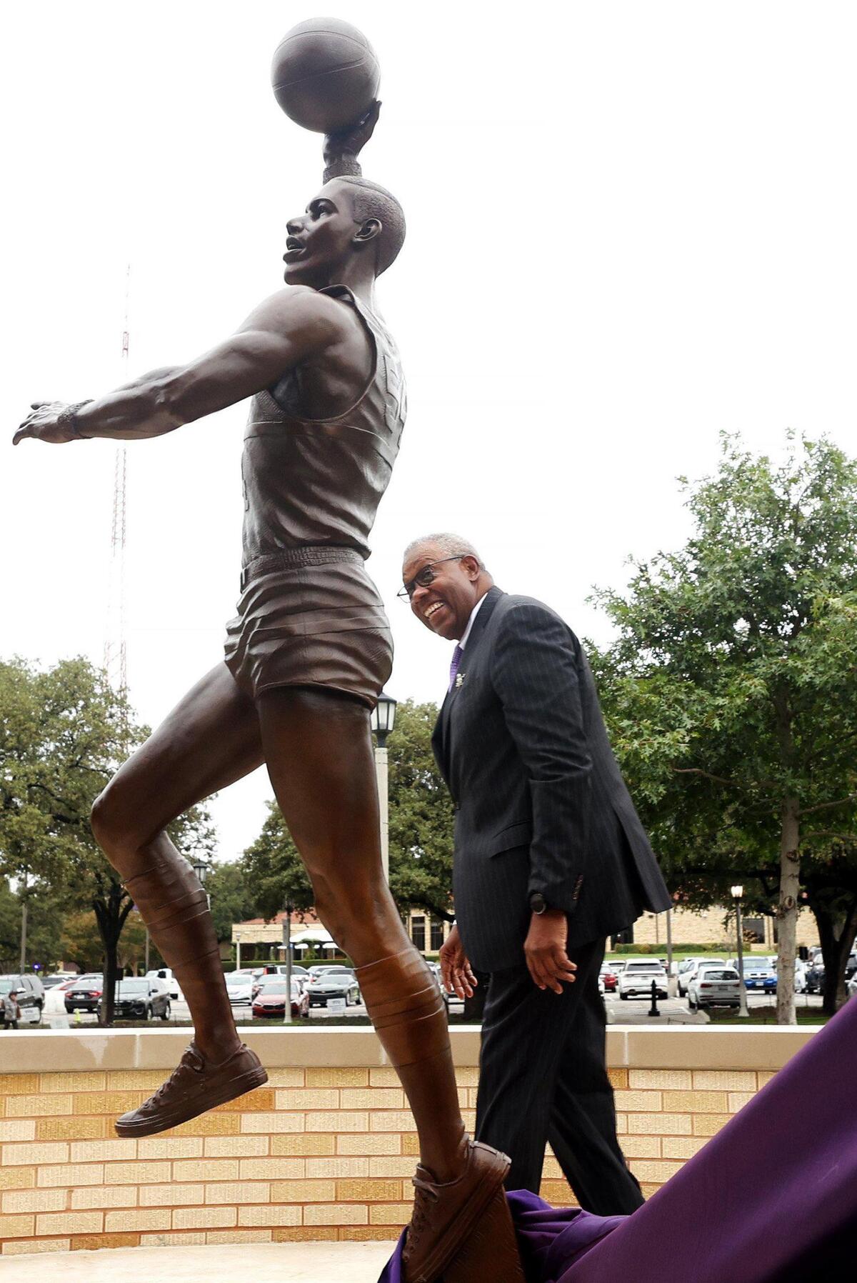 James Cash looks at a statue of himself for the first time after it was unveiled at TCU on Friday, November 11, 2022. Cash was the first Black student-athlete at TCU and first Black basketball player in the Southwest Conference.