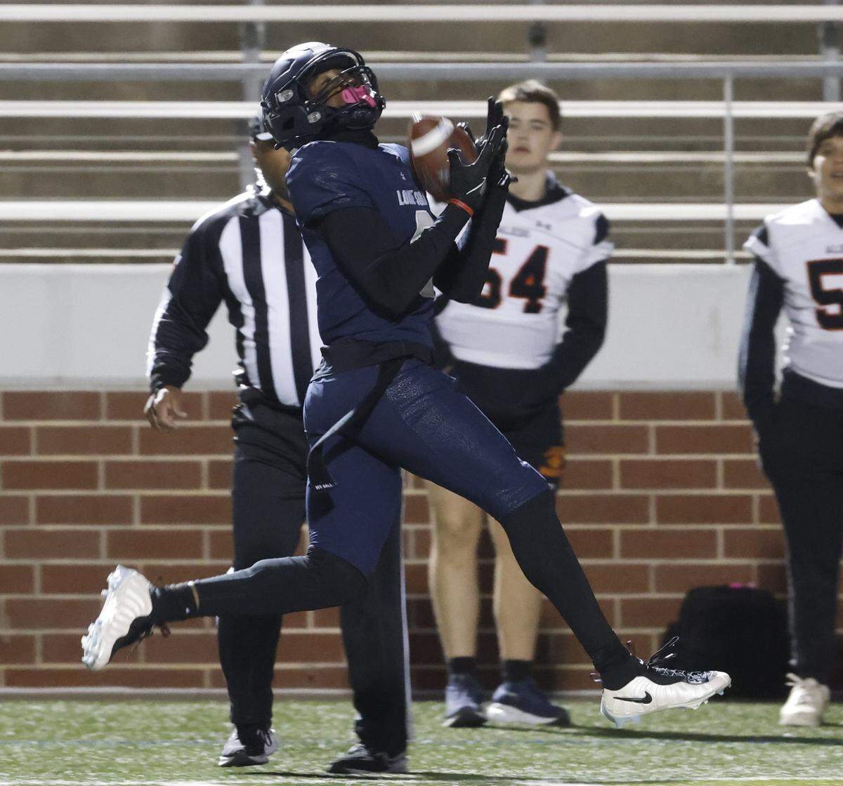Frisco Lone Star receiver Davian Groce hauls in his first touchdown pass against Aledo during the first half of a Class 5A Division I state semifinal Friday at Newsom Stadium in Mansfield.