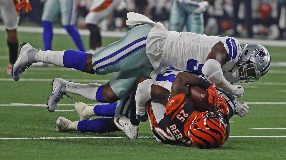 Cowboys defensive end Taco Charlton and defensive back Tyree Robinson flatten Bengals running back Giovani Bernard during the second quarter of Saturday’s preseason game at AT&T Stadium.