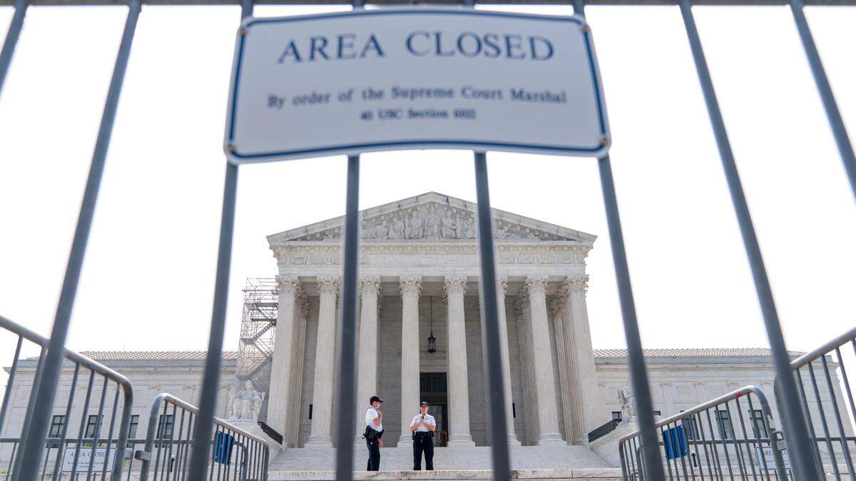Security works on the steps of the Supreme Court on Friday as decisions are expected in Washington. A year after its sweeping gun rights ruling, the Supreme Court has agreed to decide whether judges are going too far in striking down restrictions on firearms.