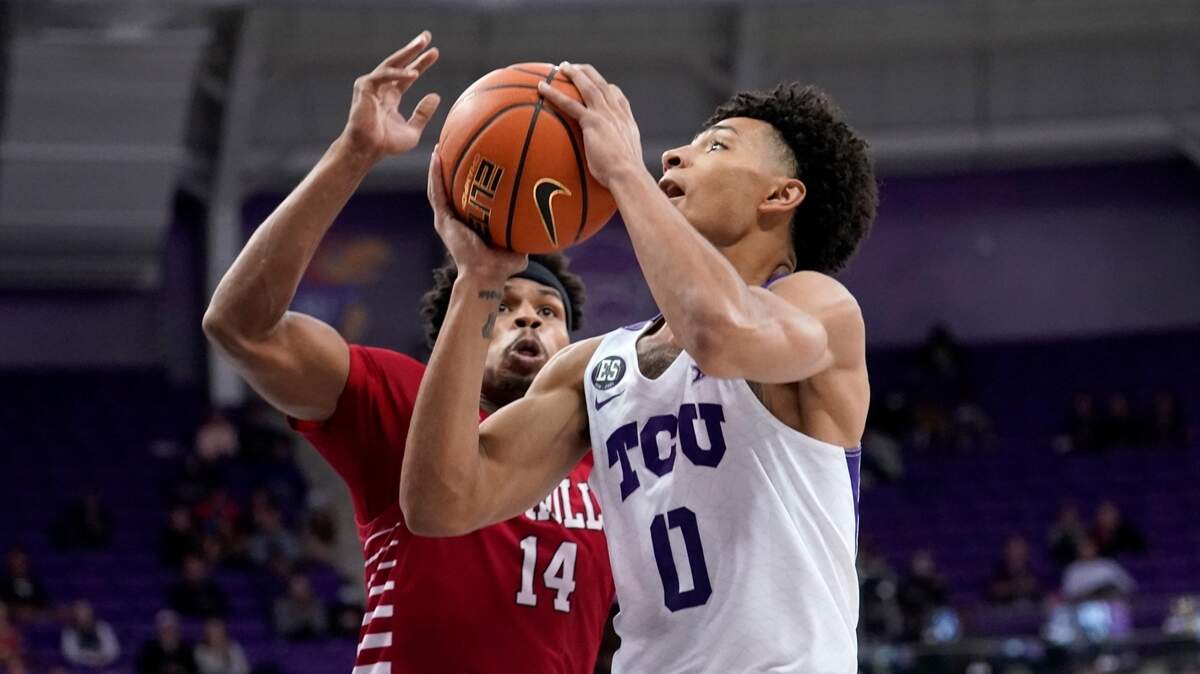 Guard Micah Peavy drives to the basket for a shot as Nicholls State’s Devante Carter defends in the second half of TCU’s 63-50 win Thursday night in Fort Worth.