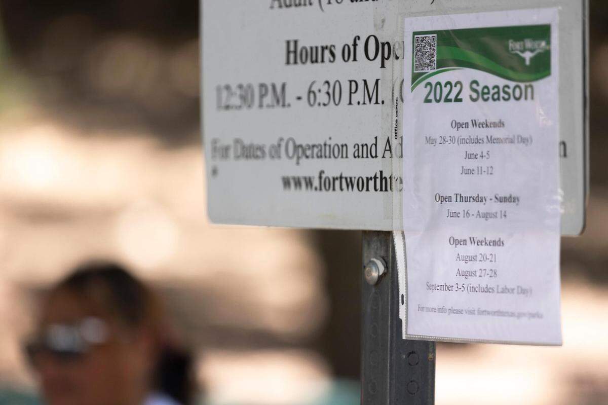 A sign shows altered hours of operation at the Forest Park pool in Fort Worth, Texas, on Friday, June 10, 2022.