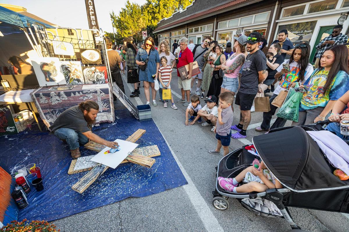 Spin artist Daniel Cannariato creates a painting using his man-made contraption in front of a crowd during the Arts Goggle event on Magnolia Avenue in Fort Worth on Saturday, Oct. 19, 2024.